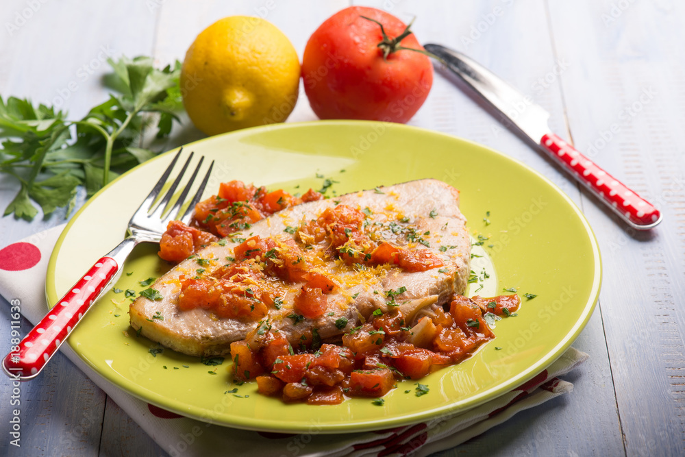 swordfish with fresh tomatoes and grated lemon peel,selective focus swordfish with fresh tomatoes and grated lemon peel,selective focus