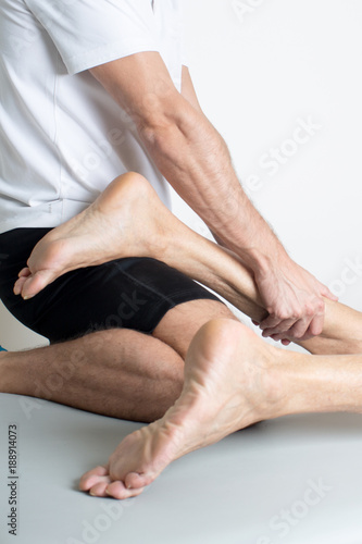 Massage therapist giving a leg massage