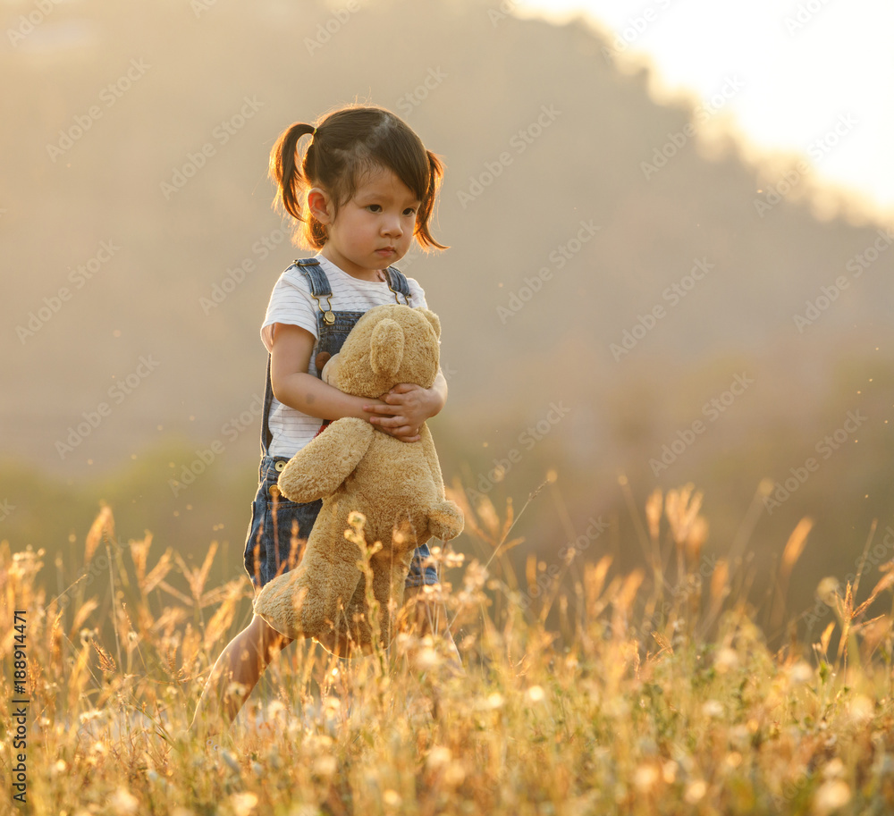 Sad little girl feeling alone in the park concept. Lonely ...