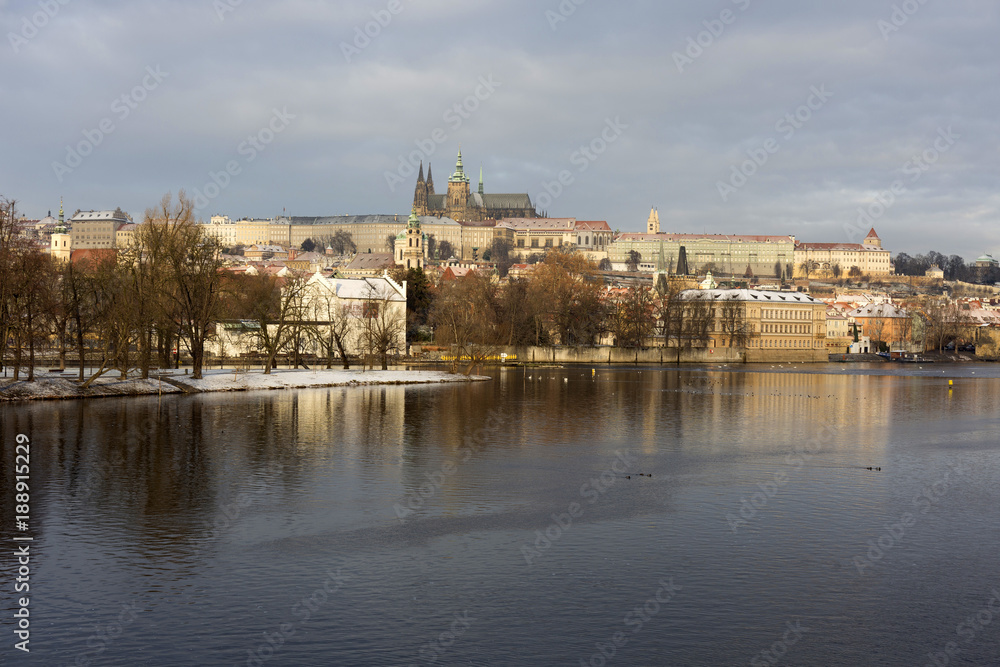 Snowy Prague Lesser Town with Prague Castle, St. Nicholas' Cathedral and Charles Bridge, Czech republic