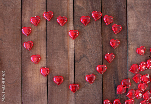 heart lined with small hearts on wooden background