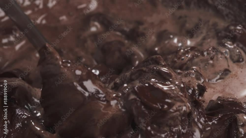 Slow motion closeup making ganache stirring with spoon Slow motion closeup making ganache stirring with spoon