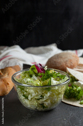 vegetarian salad with fresh herbs and bread on a dark background