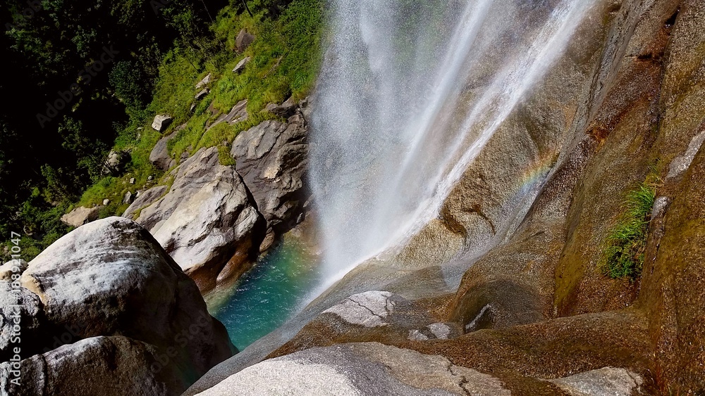 Rainbow of the small mountain waterfall , big rocks, perfectly clean water and spring green grass Rainbow of the small mountain waterfall , big rocks, perfectly clean water and spring green grass
