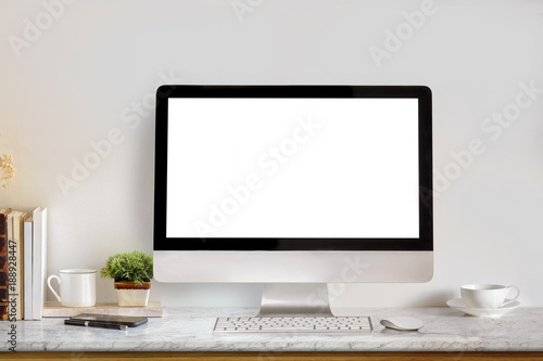 Mock up workspace with blank screen desktop computer and office supplies.