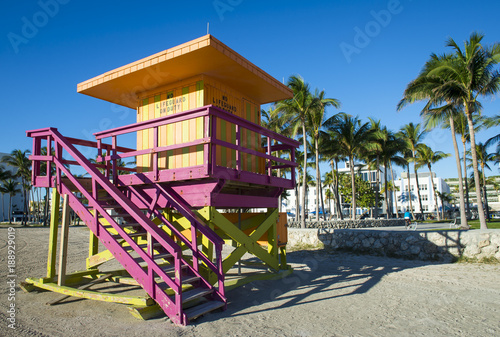 Bright scenic morning view of an iconic pastel pink lifeguard tower standing empty in Lummus Park on South Beach in Miami, Florida © lazyllama