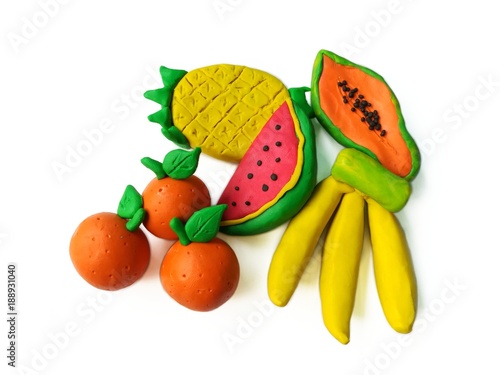 Fototapeta Naklejka Na Ścianę i Meble -  Colorful clay plasticine made are delicious fruits on white background, cute watermel banana orange papaya pineapple dough