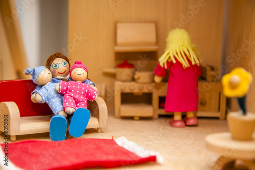 Closeup of wooden dollhouse family photo