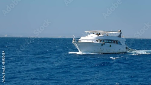 White pleasure motor ship in the stormy red sea 4k