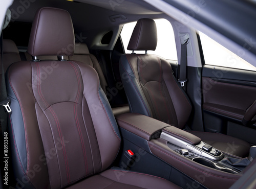 Luxury car inside. Interior of prestige modern car. Comfortable leather seats. Red perforarated leather cockpit. Isolated windows, clipping path © gargantiopa