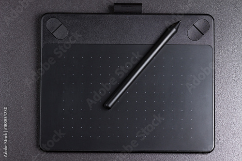Obraz na płótnie graphic tablet with pen on black background top view. w salonie