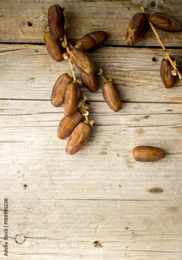 Dried dates with a copy space on the wooden background, wooden texture