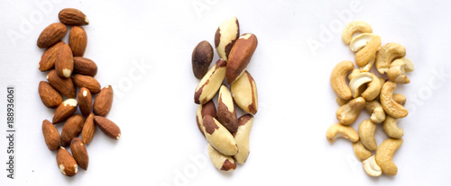 Assortment of organic nuts (Brazil nuts, cashews and almonds) on the white background