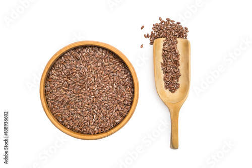 Schilderij op canvas Linseed or flax seed in a wooden bowl and a spoon to the right seen from above i