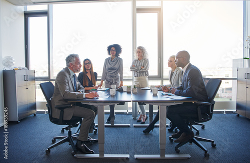 Businesspeople talking around a table in a modern office
