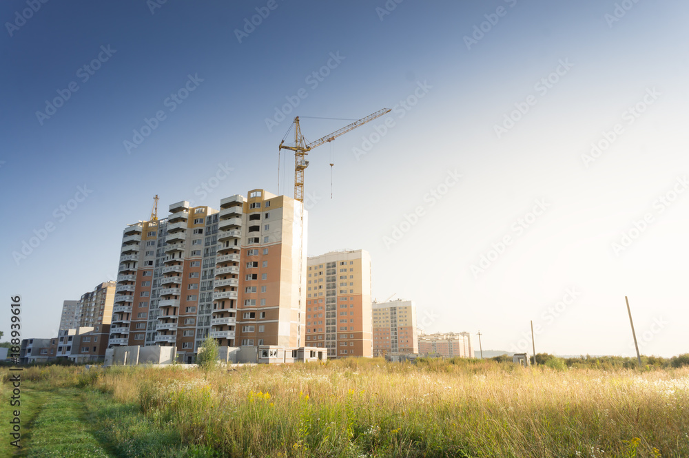 Modern high rise buildings and new structures with cranes in the Modern high rise buildings and new structures with cranes in the
