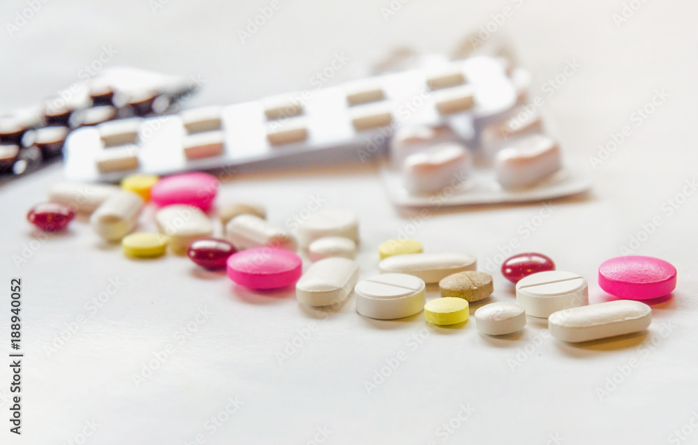 Close-up of the pills on the white background, The drug and capsule pills on the floor, Pile of the drug and pills on the white background. Close-up of the pills on the white background, The drug and capsule pills on the floor, Pile of the drug and pills on the white background.