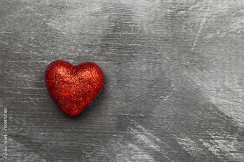 Red heart on a dark background. Top view, copy space