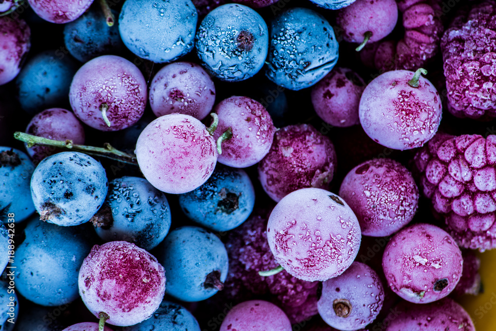 frozen berries, black currant, red currant, raspberry, blueberry. top view. macro. Treatment inspired by Pantone’s 2018 Color of the Year, Ultra Violet - obrazy, fototapety, plakaty 