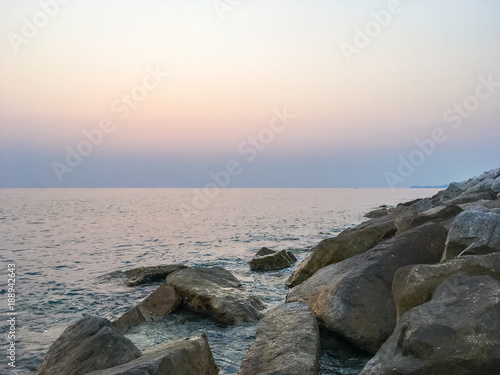 Peaceful and beautiful scene of dawn sky and sunlight at sunset beach in Thailand