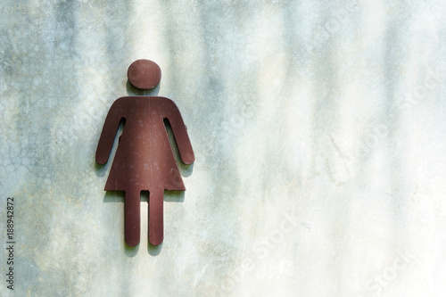 female symbol or sign on the cement wall in front of the lavatory or toilet