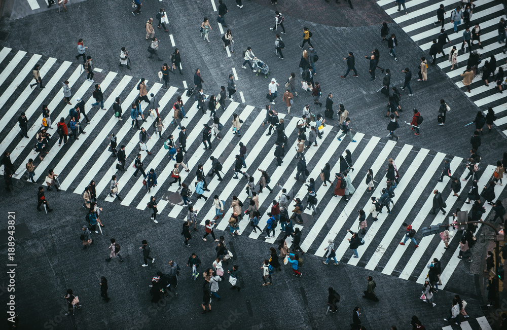Obraz premium Msza ludzi przechodzących przez ulicę w Tokio
