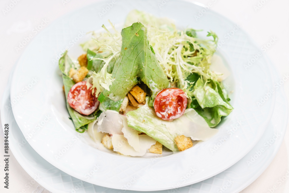 caesar salad on the white plate caesar salad on the white plate