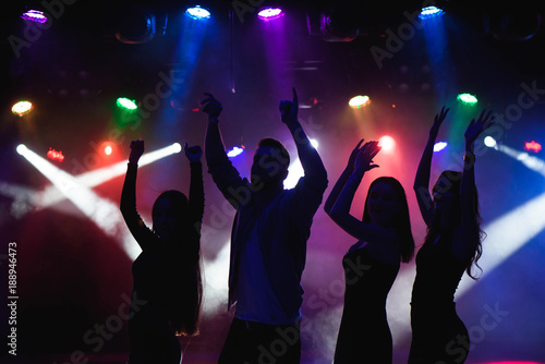 Fototapeta Naklejka Na Ścianę i Meble -  party, holidays, celebration, nightlife and people concept - group of happy friends dancing in night club