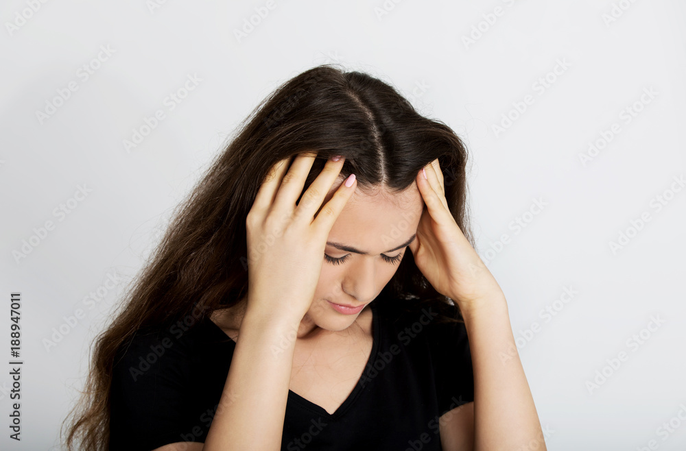 Portrait of stressed and depressed teen holding her head. Portrait of stressed and depressed teen holding her head.
