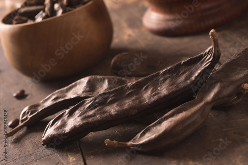 фотографія carob pods on wood
