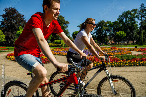 Healthy lifestyle - people riding bicycles in city park