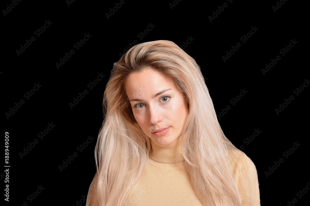 Portrait of blond girl with long beautiful hair on black background Portrait of blond girl with long beautiful hair on black background
