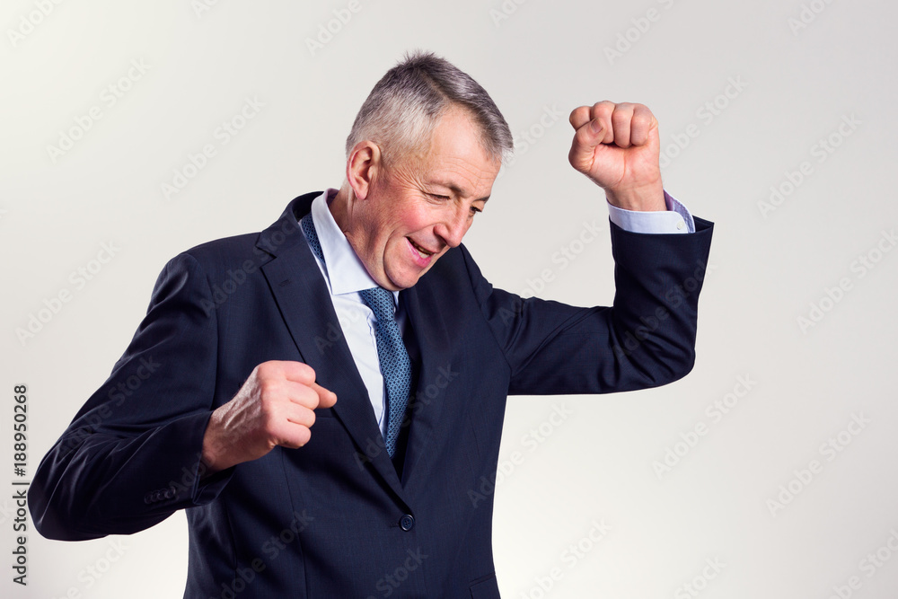 Portrait of a successful mid age businessman who is exulting with tight fists. Portrait of a successful mid age businessman who is exulting with tight fists.