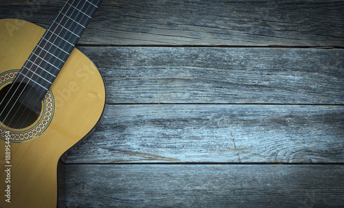 Classical guitar on a wooden background
