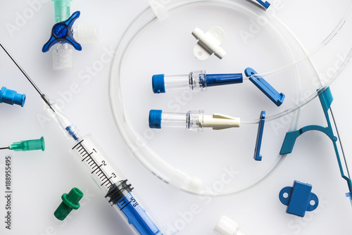 Image of neatly arranged syringe with needle and plastic tubes for central venous catheter insertion on a white background photo