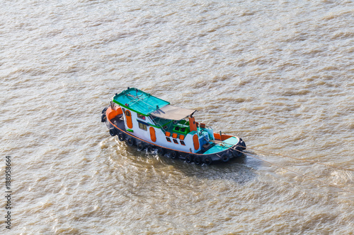 Tugboat brings cargo in Chao Phraya River