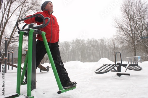 Mature man. Exercise equioment in the Park. A htalthy way of life. 1 photo