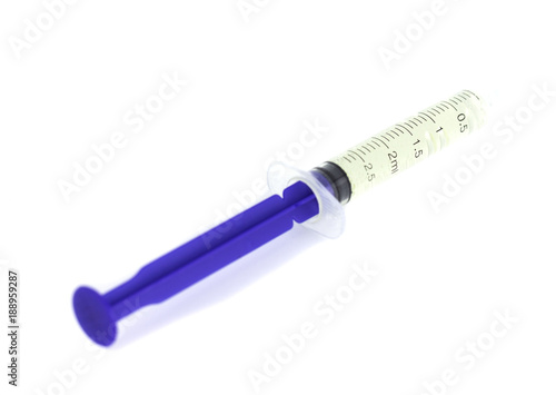 Isolated syringe with medicine on white