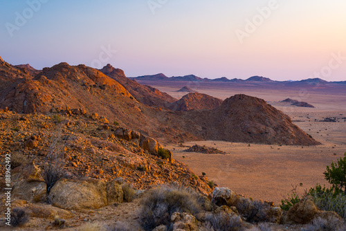 Photos Rocky desert at dusk, colorful sunset over the Namib desert, Namibia, Africa, glowing rocks and canyon