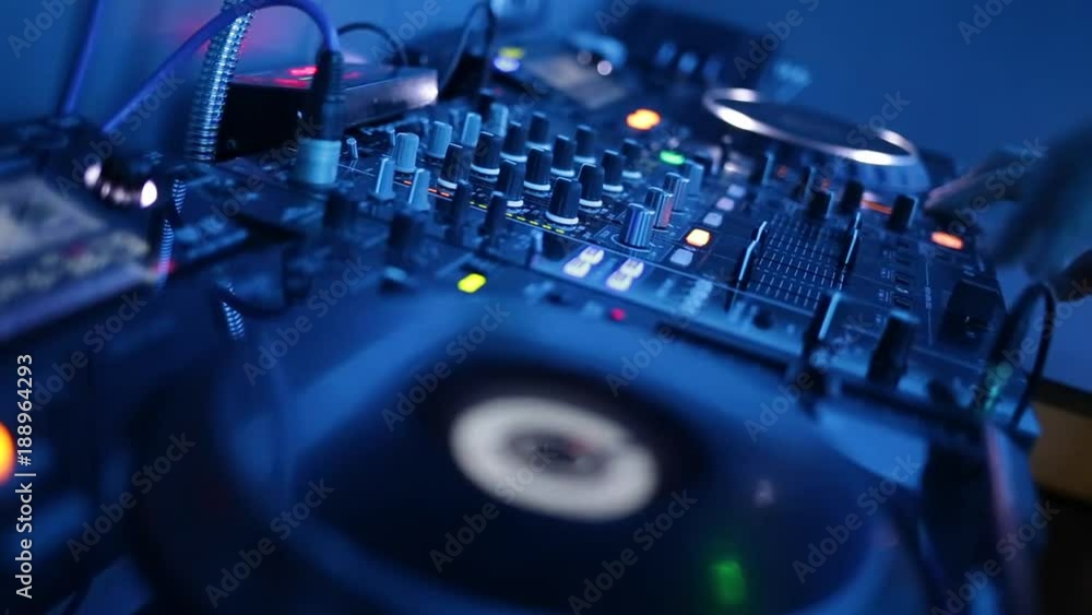 Dj hands playing and mixing music in a nightclub Dj hands playing and mixing music in a nightclub