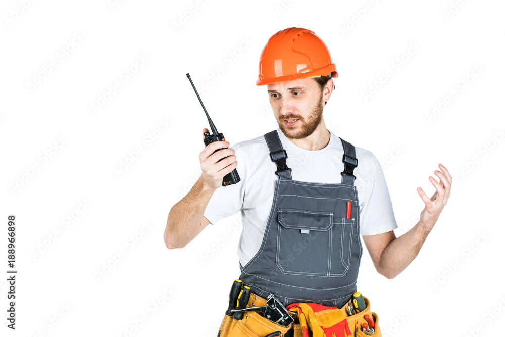 The builder talks, swears on thewalkie-talkie. isolated on white background The builder talks, swears on thewalkie-talkie. isolated on white background