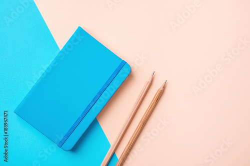 Writing Notepad Wood Pencils on Contrast Blue Peach Pink Pastel Color Background Combination. Business Education Routine Organization Planning Concept. Elegant Style Copy Space