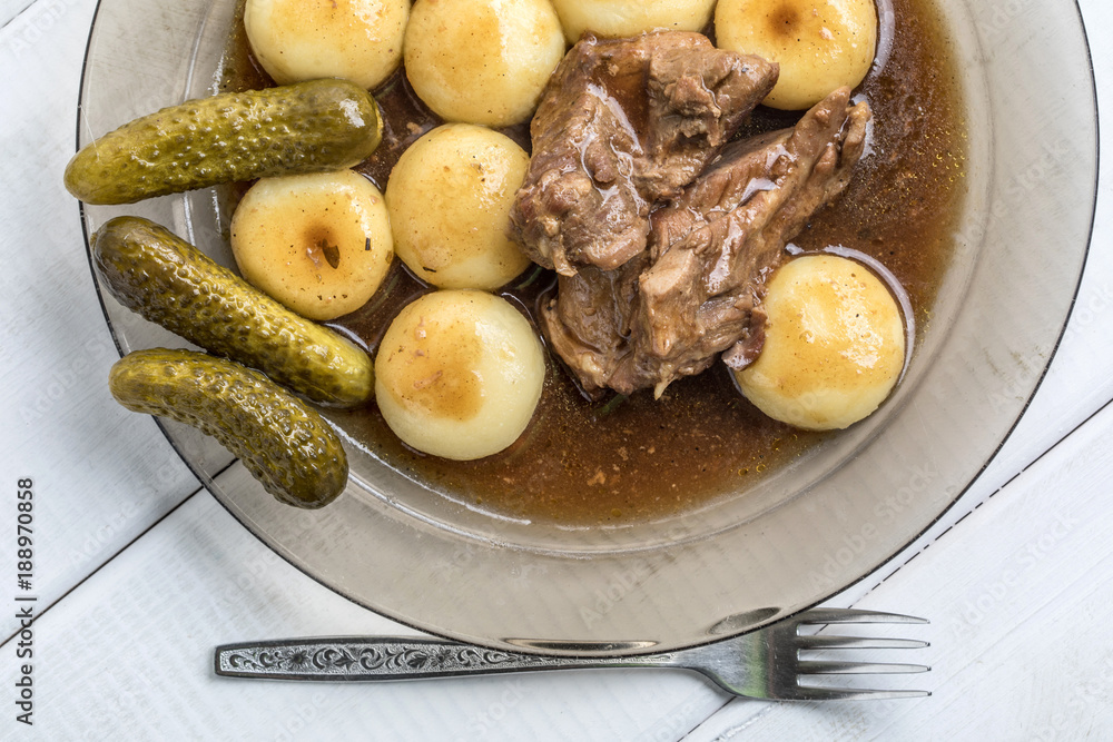 Stewed turkey meat served with silesian dumplings and sauce. Stewed turkey meat served with silesian dumplings and sauce.
