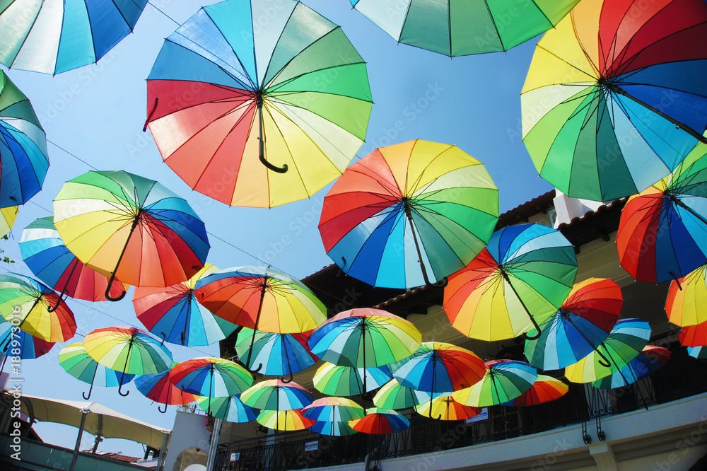Obraz premium A lot of colorful umbrellas above the street