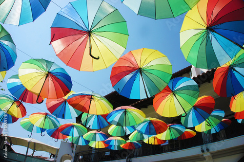 A lot of colorful umbrellas above the street