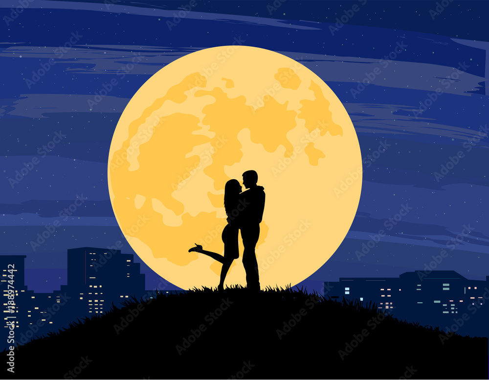 Silhouettes of a man and woman standing and kissing on a hill of grass with a big full moon, city skyline, and dark sky in the background.