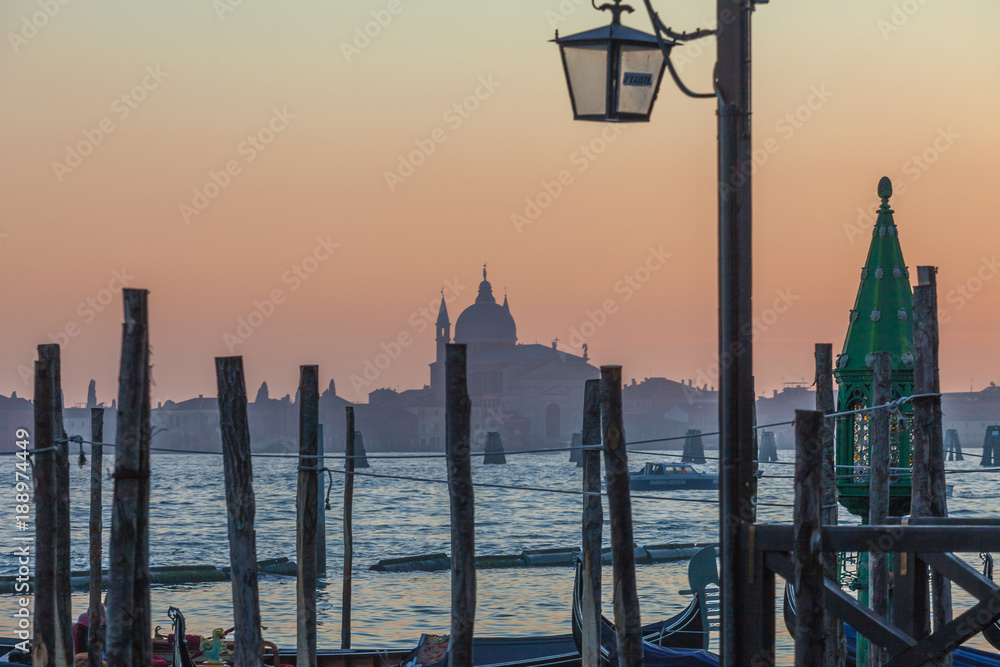 The Santissimo Redentore church and Giudecca island silhouette at sunset, Venice, Italy