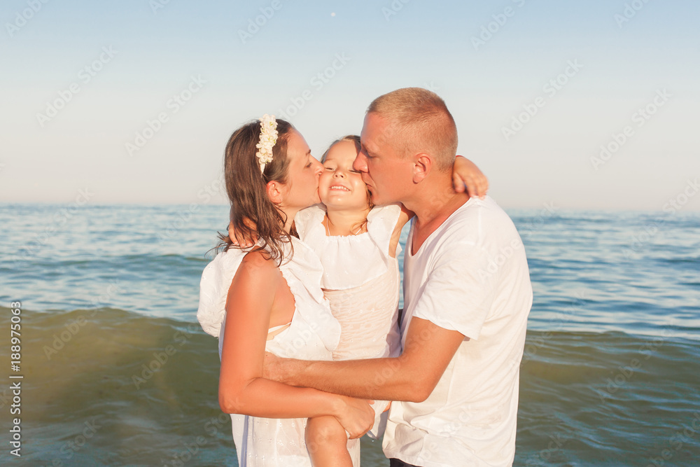 Portrait of a young family by the sea. Portrait of a young family by the sea.