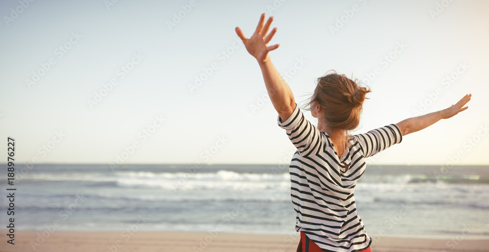 happy woman enjoying freedom with open hands on sea - obrazy, fototapety, plakaty 