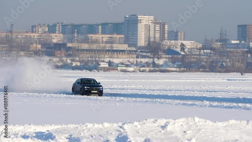 Winter tyres of a cars on a snowy road. Tires on the road are covered with snow on a winter day. Car drives on a snowy road photo